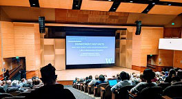 Photo of large lecture hall filled with people